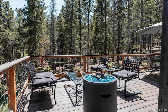 32663 Donna Dr, Conifer, CO 80433 - wooden deck featuring a forest view
