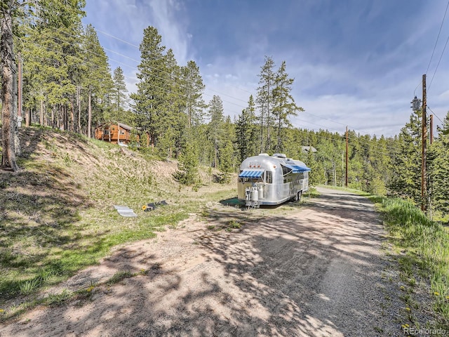 32663 Donna Dr, Conifer, CO 80433 - view of dirt / gravel road with a view of trees