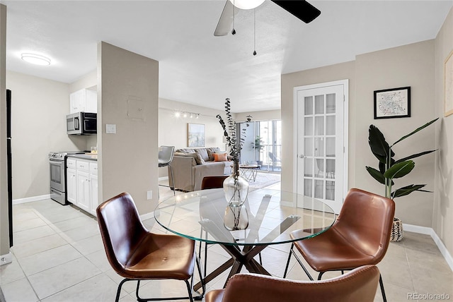 dining space featuring ceiling fan and light tile patterned floors