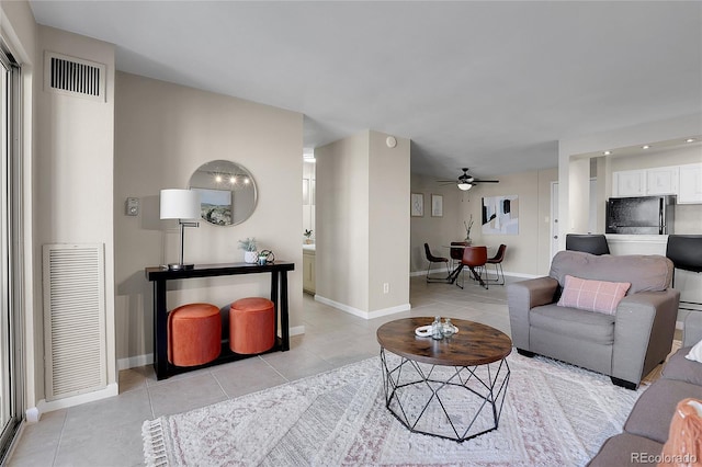 tiled living room with ceiling fan