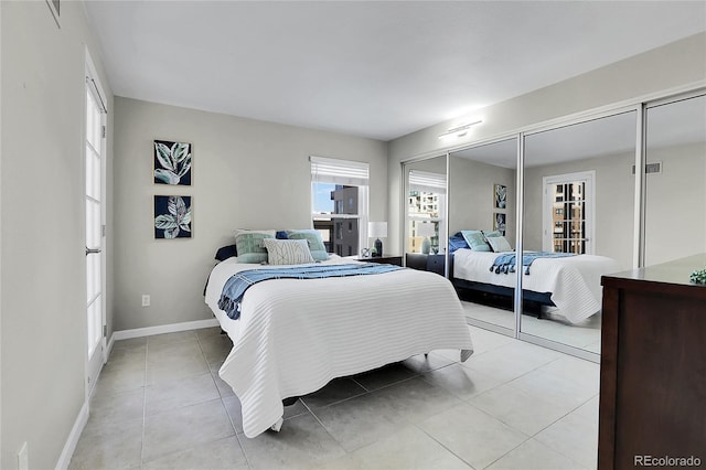 bedroom featuring light tile patterned floors and a closet