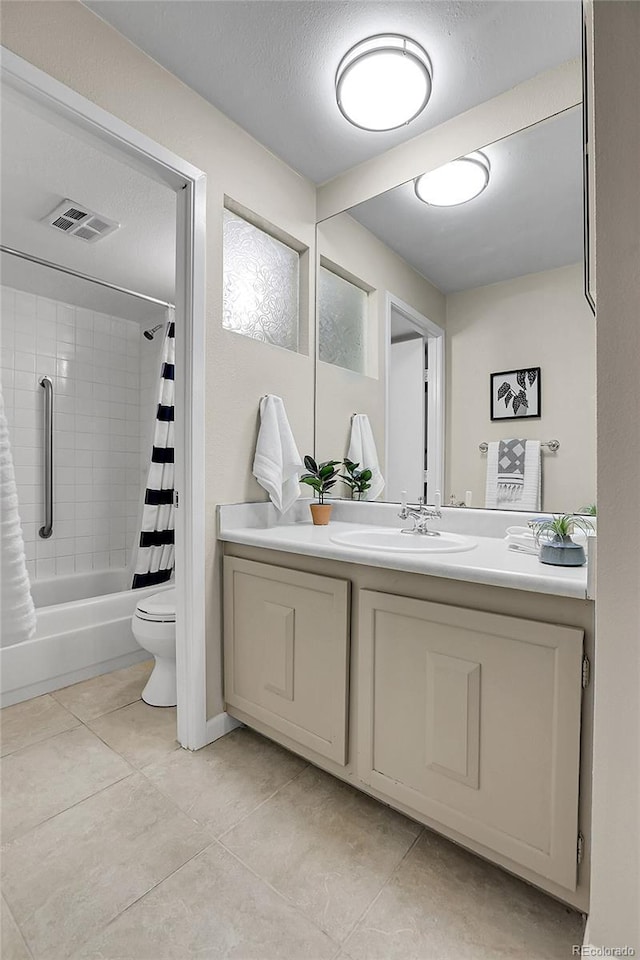 full bathroom featuring tile patterned floors, a textured ceiling, vanity, shower / bathtub combination with curtain, and toilet