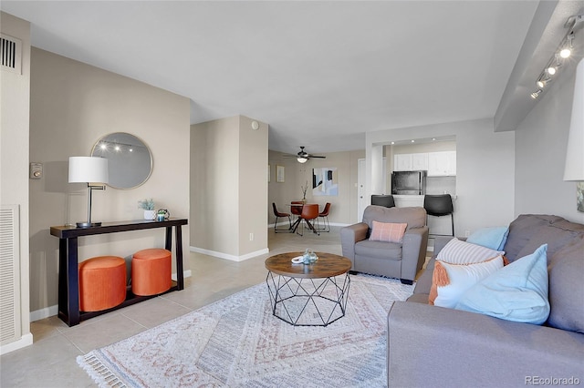 living room with ceiling fan and light tile patterned floors