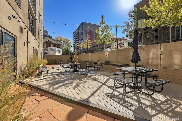 wooden terrace with a patio area