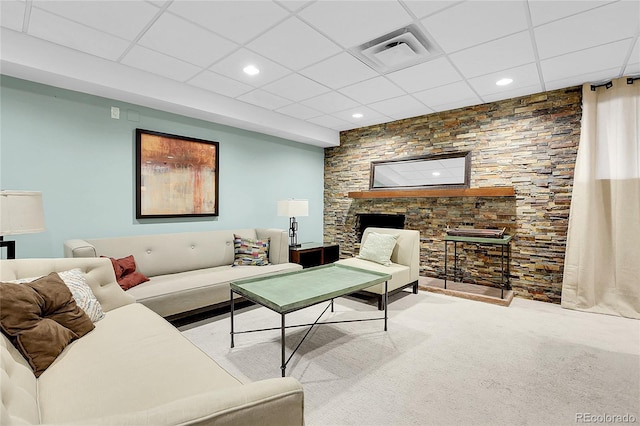 living room featuring a paneled ceiling and carpet floors