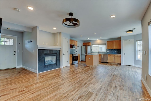 3769 Dahlia St, Denver, CO 80207 - kitchen with stainless steel appliances, open floor plan, decorative backsplash, baseboards, and recessed lighting