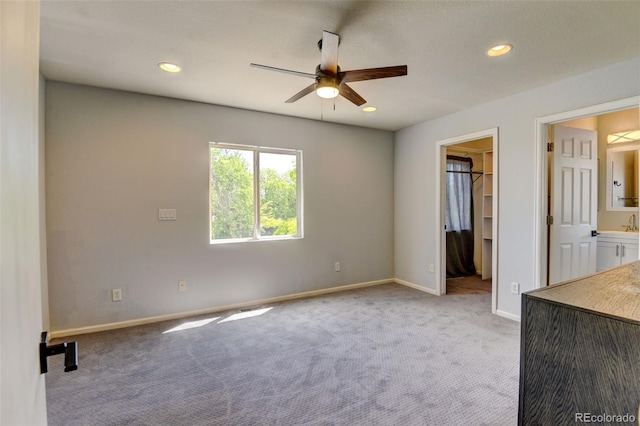 3769 Dahlia St, Denver, CO 80207 - unfurnished bedroom featuring carpet floors, baseboards, a walk in closet, recessed lighting, and connected bathroom