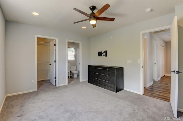 3769 Dahlia St, Denver, CO 80207 - unfurnished bedroom with carpet, baseboards, a walk in closet, ensuite bathroom, and a ceiling fan
