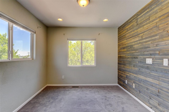 3769 Dahlia St, Denver, CO 80207 - unfurnished room featuring wood walls, carpet flooring, recessed lighting, and baseboards