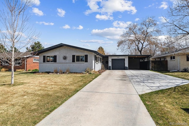 view of front of house featuring brick siding, an attached garage, a front lawn, and concrete driveway