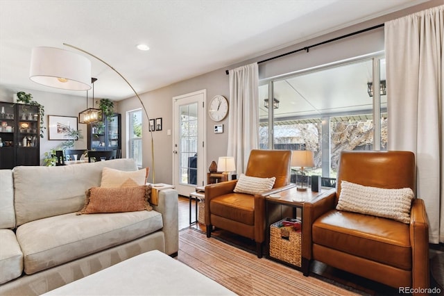 living area with recessed lighting and wood finished floors