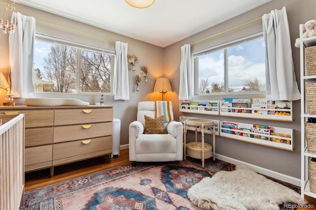 living area with wood finished floors and baseboards