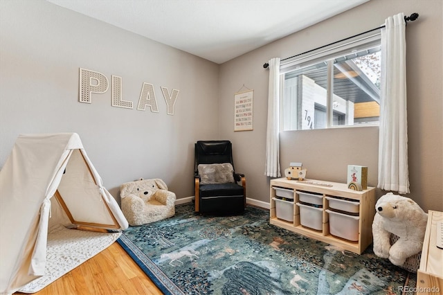 living area with wood finished floors and baseboards