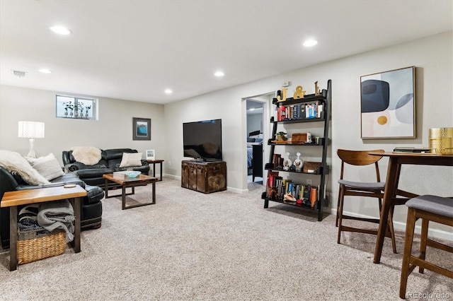 carpeted living room featuring baseboards, visible vents, and recessed lighting