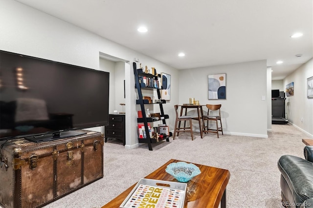 carpeted living area featuring baseboards and recessed lighting