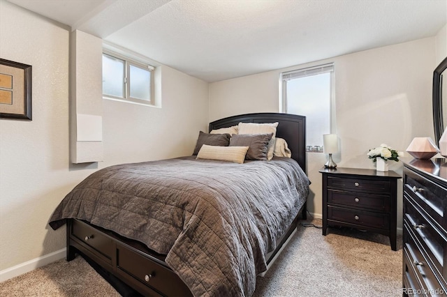bedroom featuring baseboards and light colored carpet