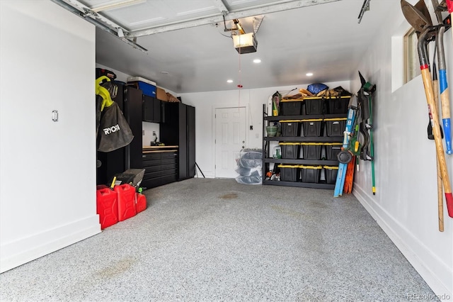 garage featuring a garage door opener and recessed lighting