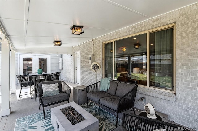 view of patio / terrace with an outdoor living space with a fire pit