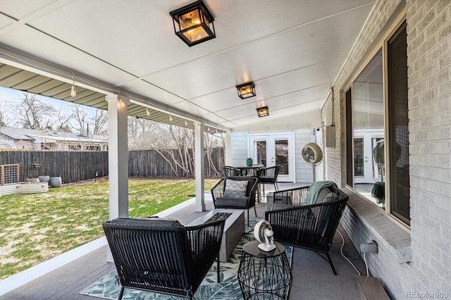 view of patio with an outdoor living space, french doors, and a fenced backyard