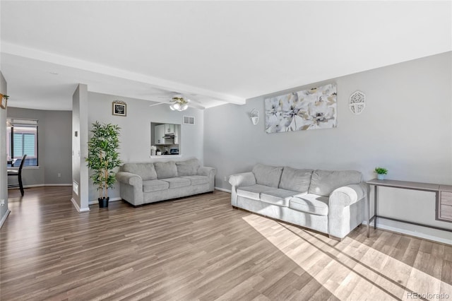 living room featuring hardwood / wood-style flooring and ceiling fan