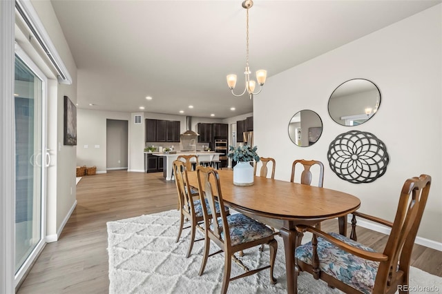 1677 Meagan Way, Erie, CO 80516 - dining area with recessed lighting, baseboards, light wood-style floors, and a chandelier