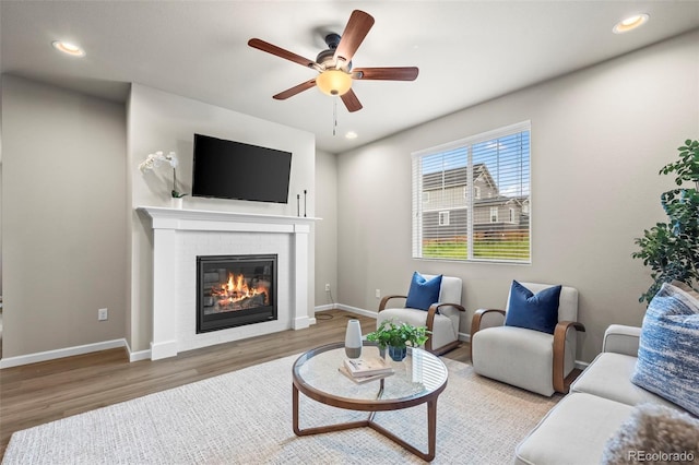 1677 Meagan Way, Erie, CO 80516 - living room with wood finished floors, a brick fireplace, a ceiling fan, recessed lighting, and baseboards