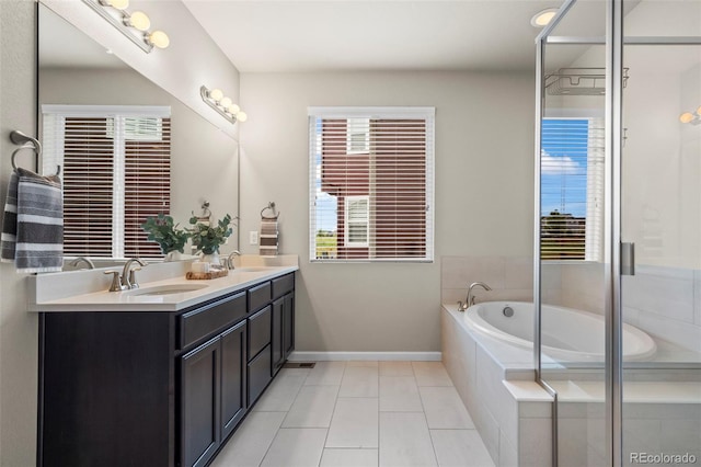 1677 Meagan Way, Erie, CO 80516 - bathroom with double vanity, a bath, baseboards, and tile patterned floors