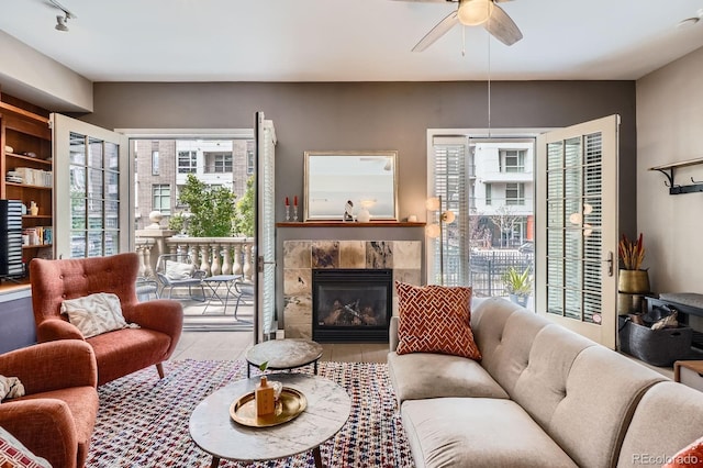 1950 N Logan St Unit 108, Denver, CO 80203 - living room with ceiling fan, a tiled fireplace, and tile patterned floors
