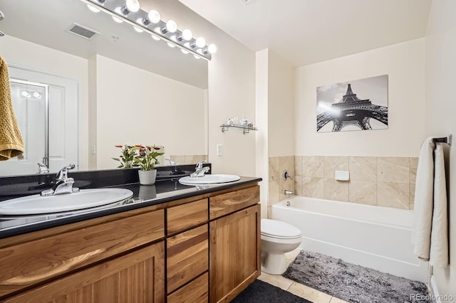 1950 N Logan St Unit 108, Denver, CO 80203 - bathroom featuring tile patterned floors, double vanity, a garden tub, and toilet