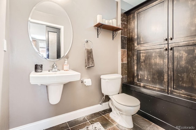 1950 N Logan St Unit 108, Denver, CO 80203 - bathroom featuring baseboards and toilet
