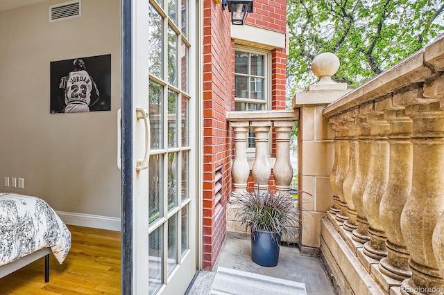 1950 N Logan St Unit 108, Denver, CO 80203 - bedroom featuring baseboards and wood finished floors