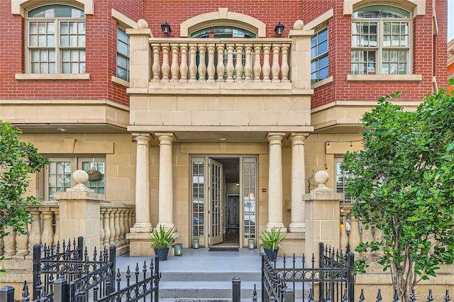 1950 N Logan St Unit 108, Denver, CO 80203 - property entrance featuring stone siding, a balcony, and brick siding