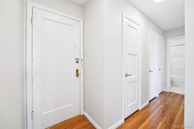 corridor with light wood-type flooring