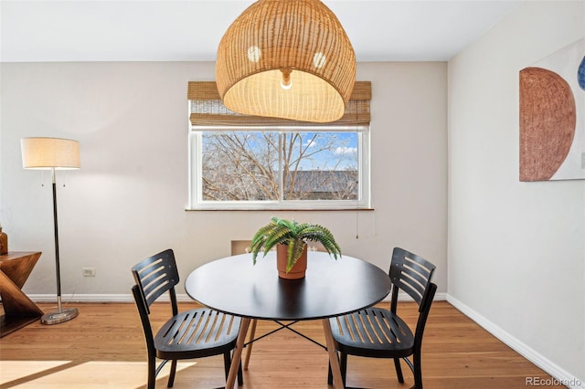 dining area featuring baseboards and wood finished floors