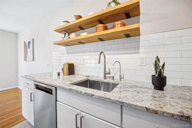 kitchen featuring a sink, dishwasher, decorative backsplash, white cabinets, and open shelves