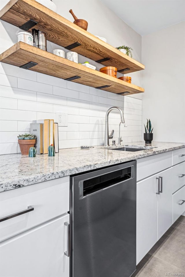 kitchen featuring a sink, white cabinets, dishwasher, and open shelves