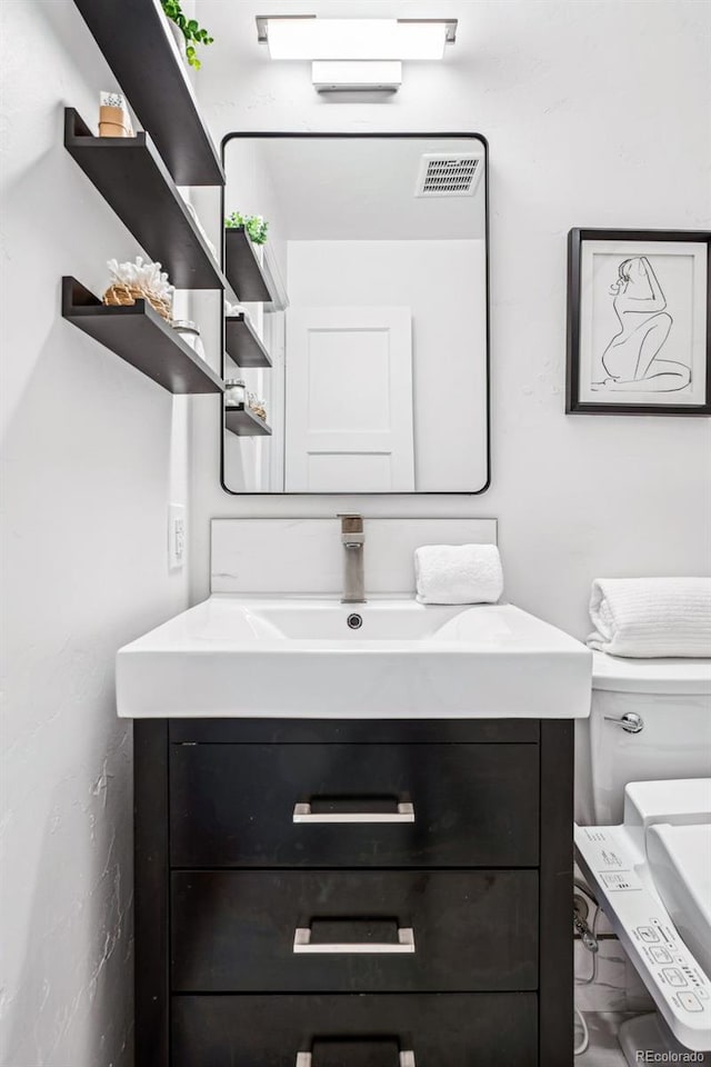 half bath featuring visible vents and vanity