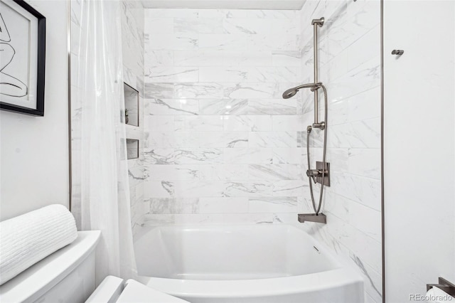 bathroom featuring shower / bath combo with shower curtain and toilet