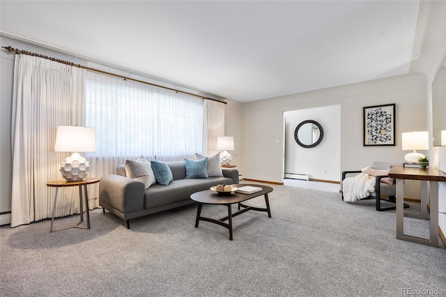 carpeted living area featuring baseboard heating and baseboards