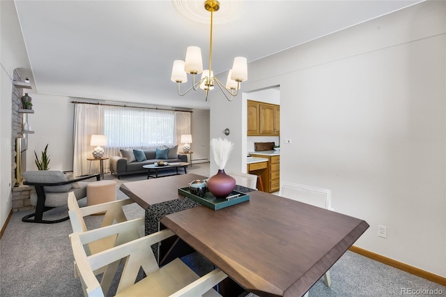 dining area featuring carpet floors, a chandelier, and baseboards