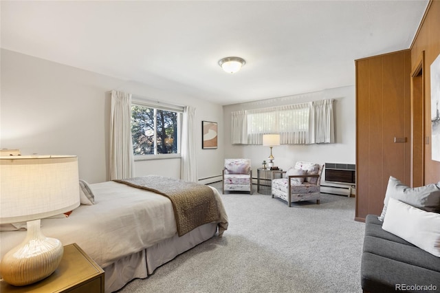 bedroom with carpet and a baseboard heating unit