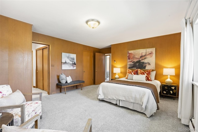 bedroom featuring carpet flooring, wooden walls, and multiple closets