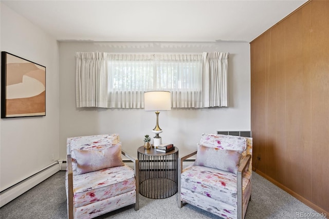 living area featuring baseboard heating and carpet floors