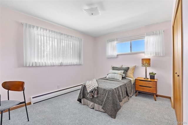 bedroom with a baseboard radiator, carpet floors, and baseboards