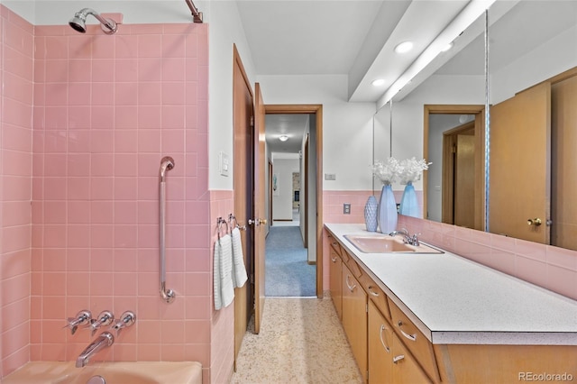 bathroom with vanity, recessed lighting, washtub / shower combination, speckle patterned floor, and wainscoting