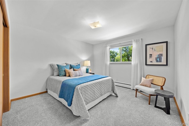 carpeted bedroom with a baseboard heating unit and baseboards