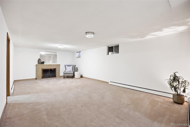 finished below grade area with a baseboard heating unit, a baseboard radiator, carpet floors, a fireplace, and baseboards