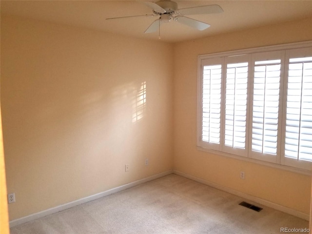 spare room featuring carpet flooring, ceiling fan, and a healthy amount of sunlight