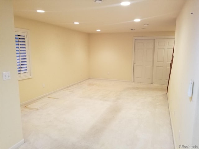 spare room featuring light colored carpet