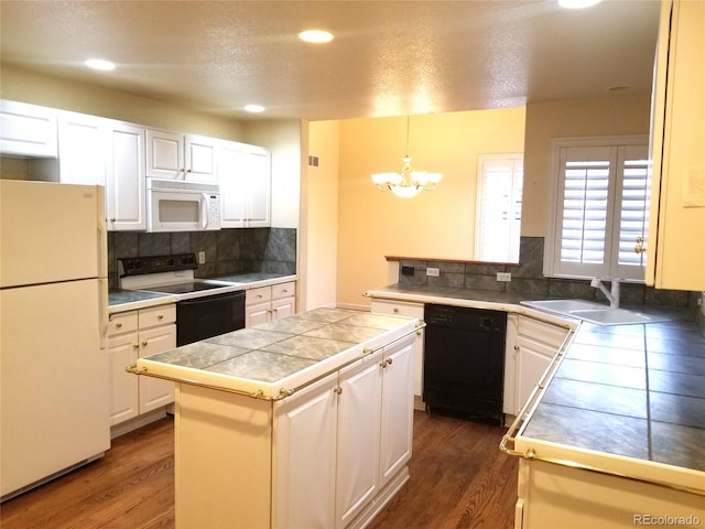 kitchen with dark hardwood / wood-style flooring, white appliances, decorative light fixtures, and white cabinetry